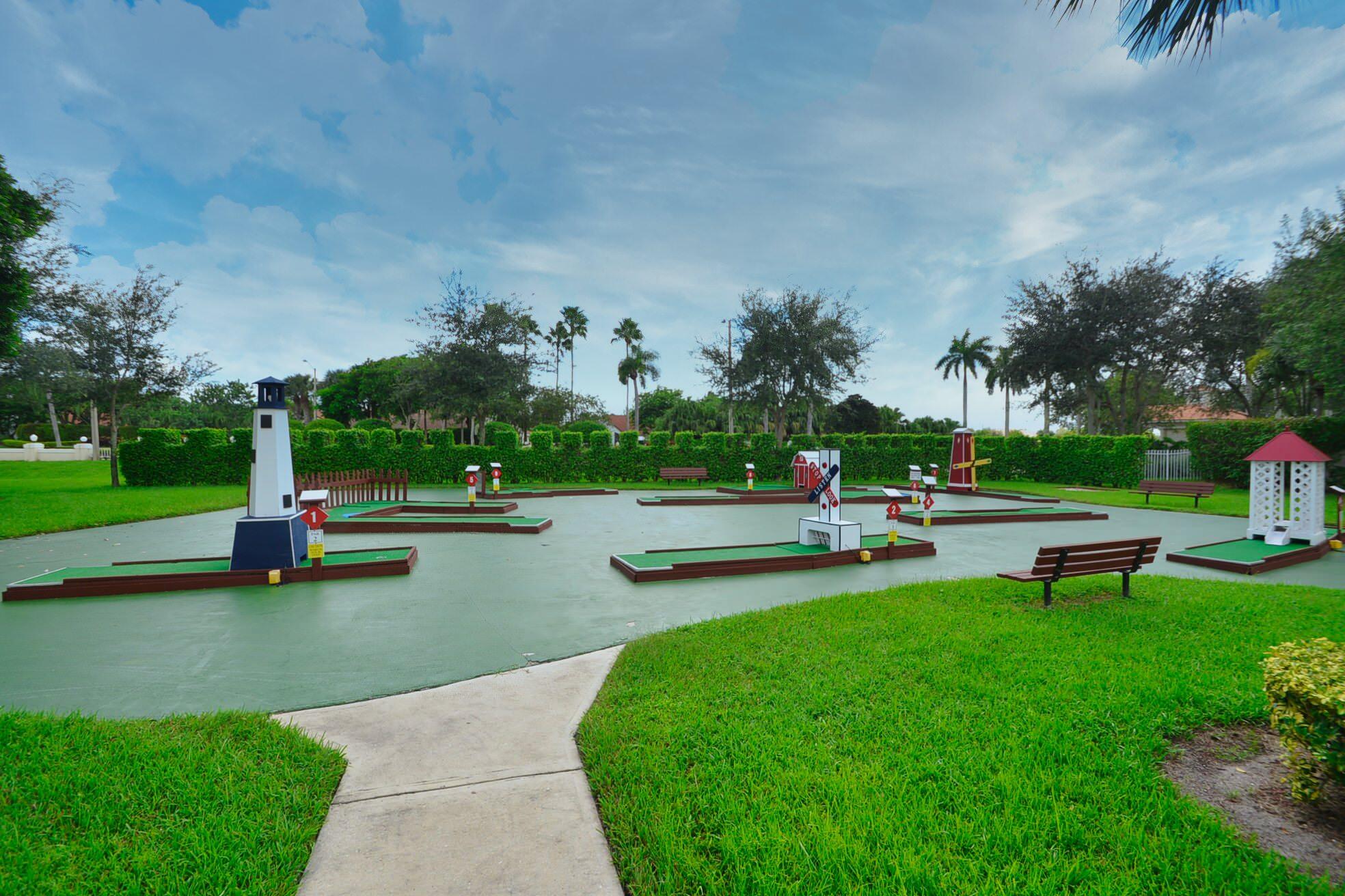 6210 Caladium Road Delray Beach, FL 33484 - Photo 42 of 59 a view of a garden with plants and bench