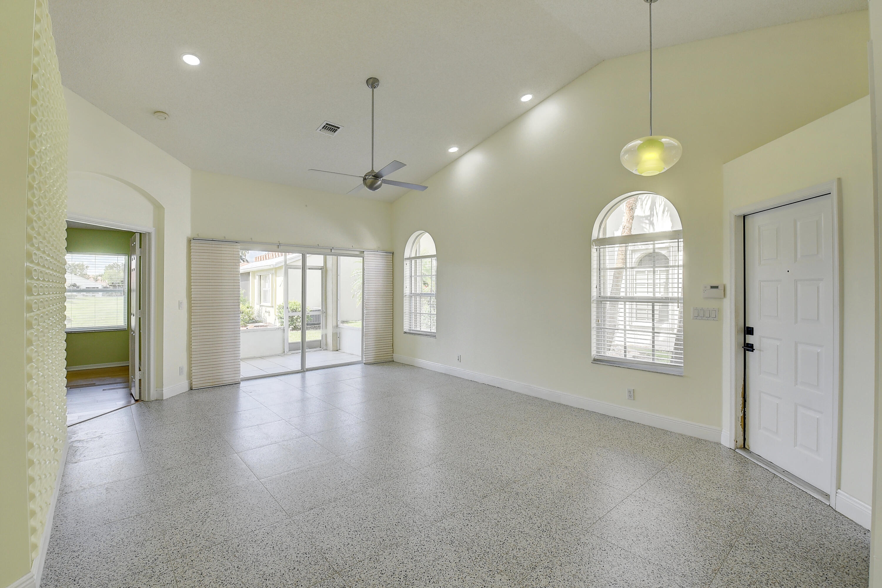 6210 Caladium Road Delray Beach, FL 33484 - Photo 6 of 59 an empty room with wooden floor and windows