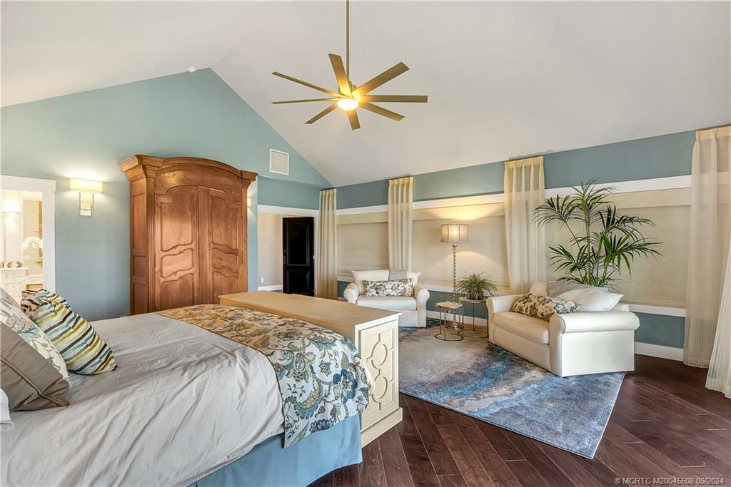 12 North Sewalls Point Road Stuart, FL 34996 - Photo 34 of 75 a bedroom with a balcony a bed and a chandelier