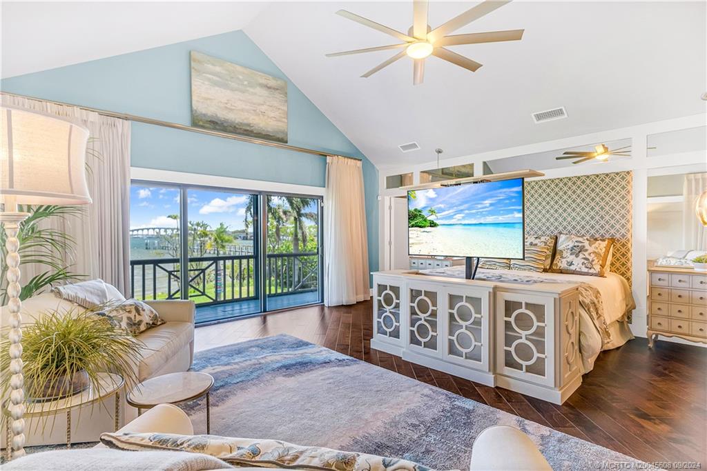 12 North Sewalls Point Road Stuart, FL 34996 - Photo 35 of 75 a spacious bedroom with a large bed and a chandelier