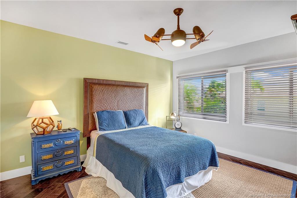 12 North Sewalls Point Road Stuart, FL 34996 - Photo 52 of 75 a bedroom with a bed and a chandelier