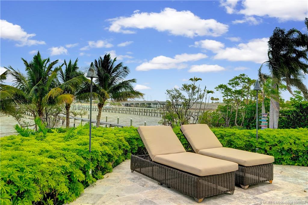 12 North Sewalls Point Road Stuart, FL 34996 - Photo 67 of 75 a view of a patio with couches plants and palm tree