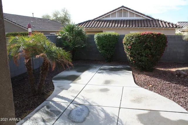 a view of a pathway with a flower garden