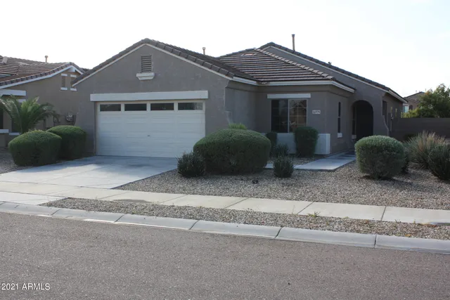 a view of a house with a yard and a large window