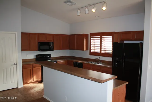 a kitchen with granite countertop a sink and a stove top oven