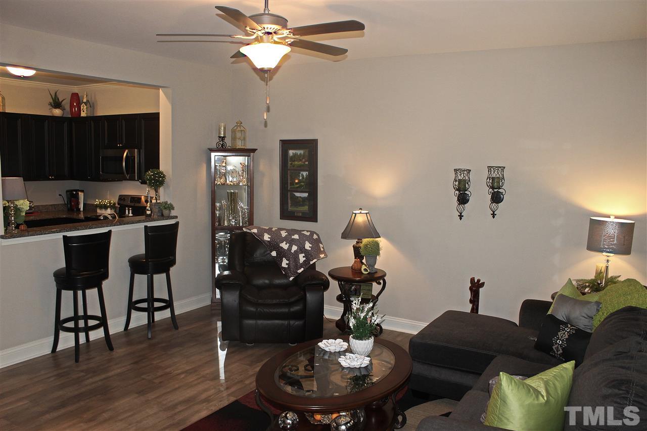 3902 Volkswalk Place Raleigh, NC 27610 - Photo 12 of 21 a living room with furniture kitchen view and a wooden floor