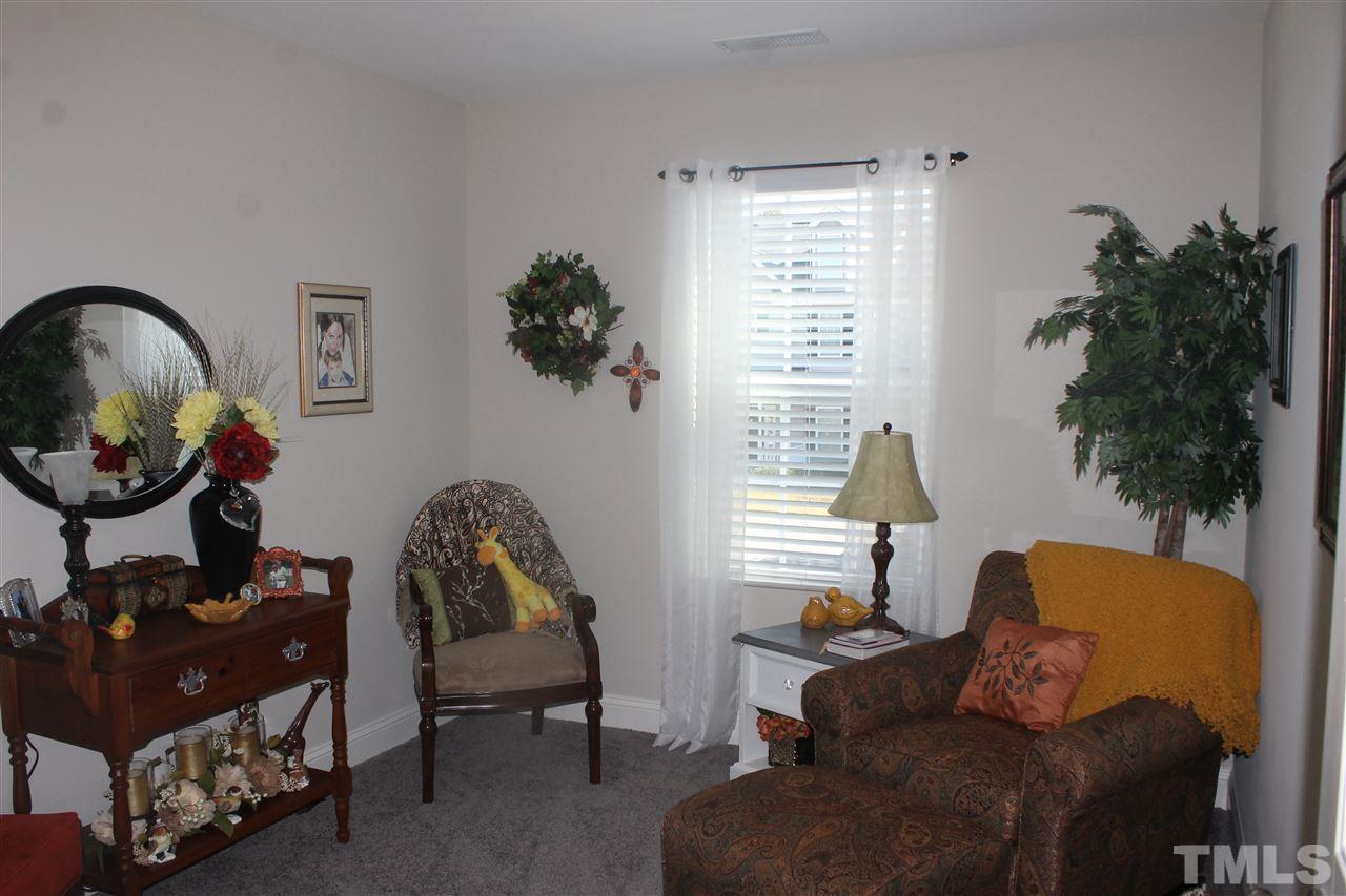 3902 Volkswalk Place Raleigh, NC 27610 - Photo 14 of 21 a living room with furniture and a window