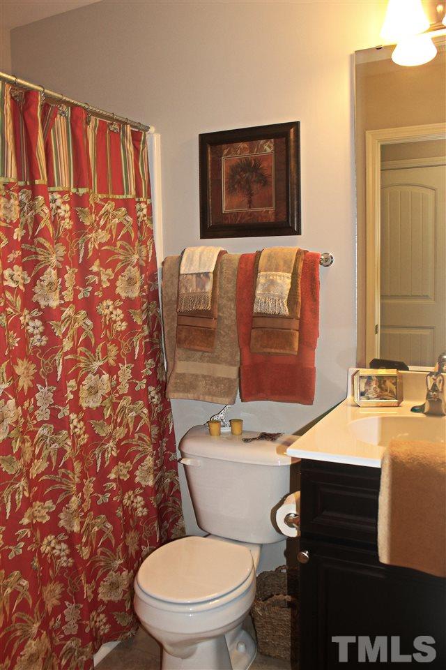 3902 Volkswalk Place Raleigh, NC 27610 - Photo 15 of 21 a bathroom with a toilet and a sink