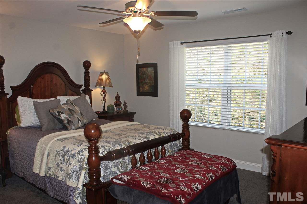 3902 Volkswalk Place Raleigh, NC 27610 - Photo 18 of 21 a bedroom with a bed and a window
