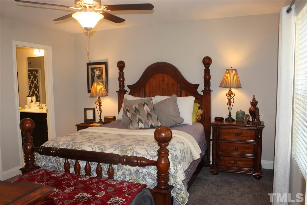 3902 Volkswalk Place Raleigh, NC 27610 - Photo 19 of 21 a bed sitting in a bedroom next to a window