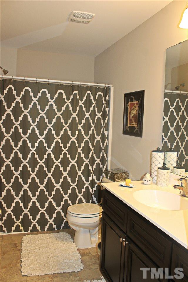 3902 Volkswalk Place Raleigh, NC 27610 - Photo 20 of 21 a bathroom with a sink and a toilet