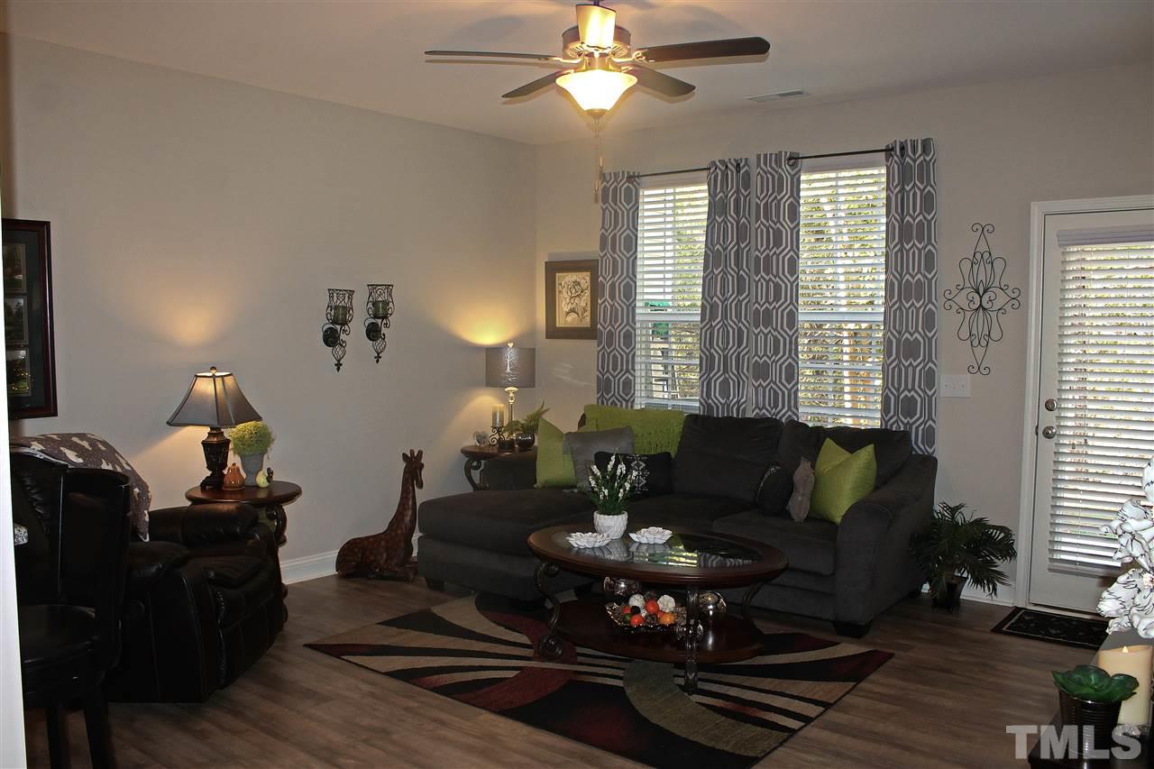 3902 Volkswalk Place Raleigh, NC 27610 - Photo 8 of 21 a living room with furniture and wooden floor