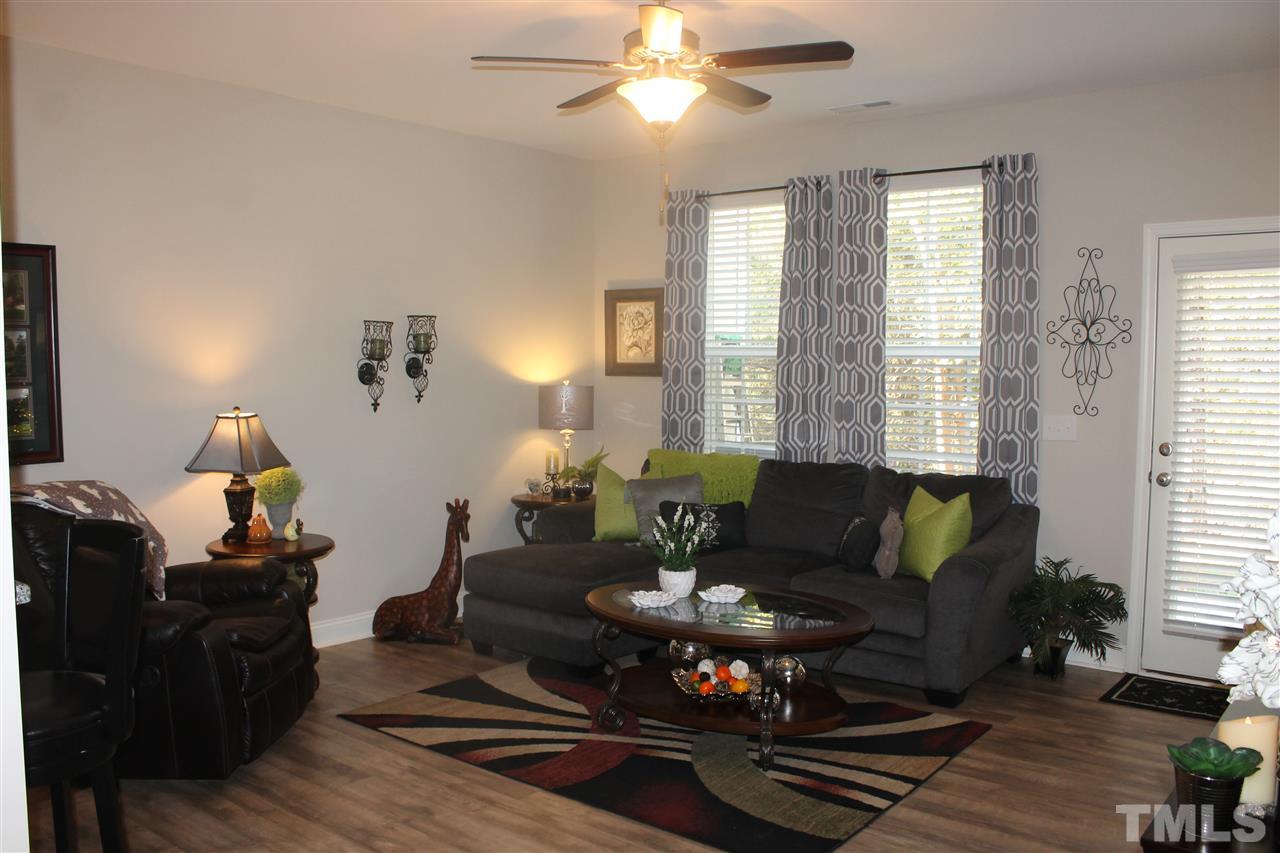 3902 Volkswalk Place Raleigh, NC 27610 - Photo 9 of 21 a living room with furniture and wooden floor