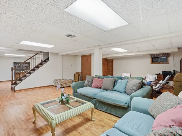 a bedroom with furniture and a wooden floor
