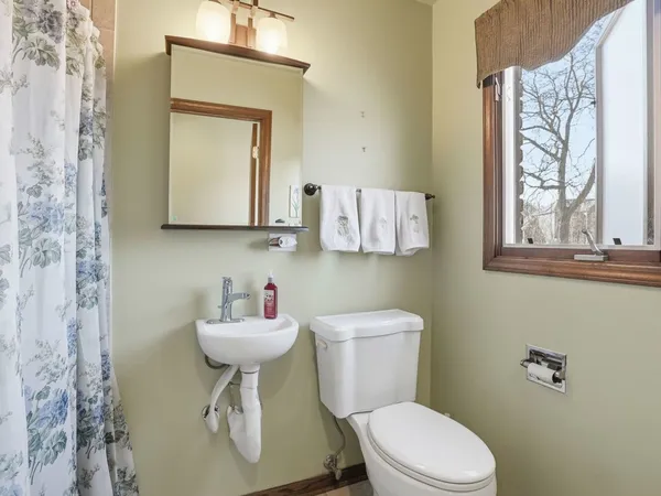 a spacious bedroom with a bed and a flat screen tv