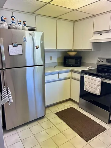 a white refrigerator freezer sitting in a kitchen