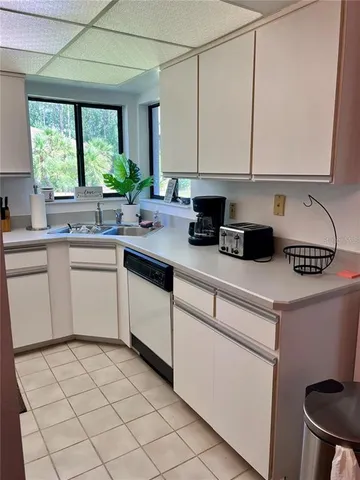 a kitchen with a sink cabinets and window