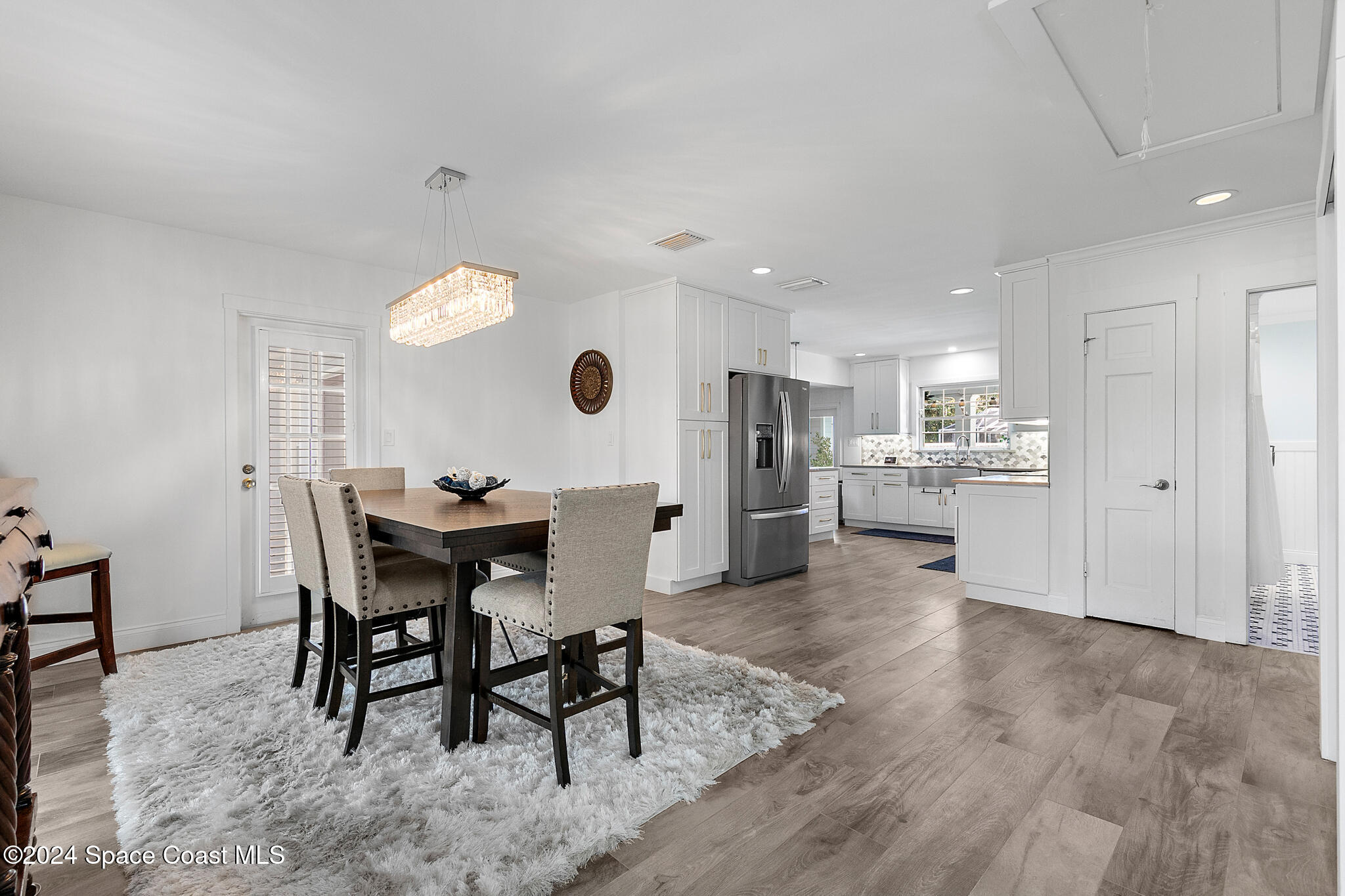 200 Melbourne Avenue Indialantic, FL 32903 - Photo 14 of 60 a view of a dining room and livingroom with furniture wooden floor and a rug