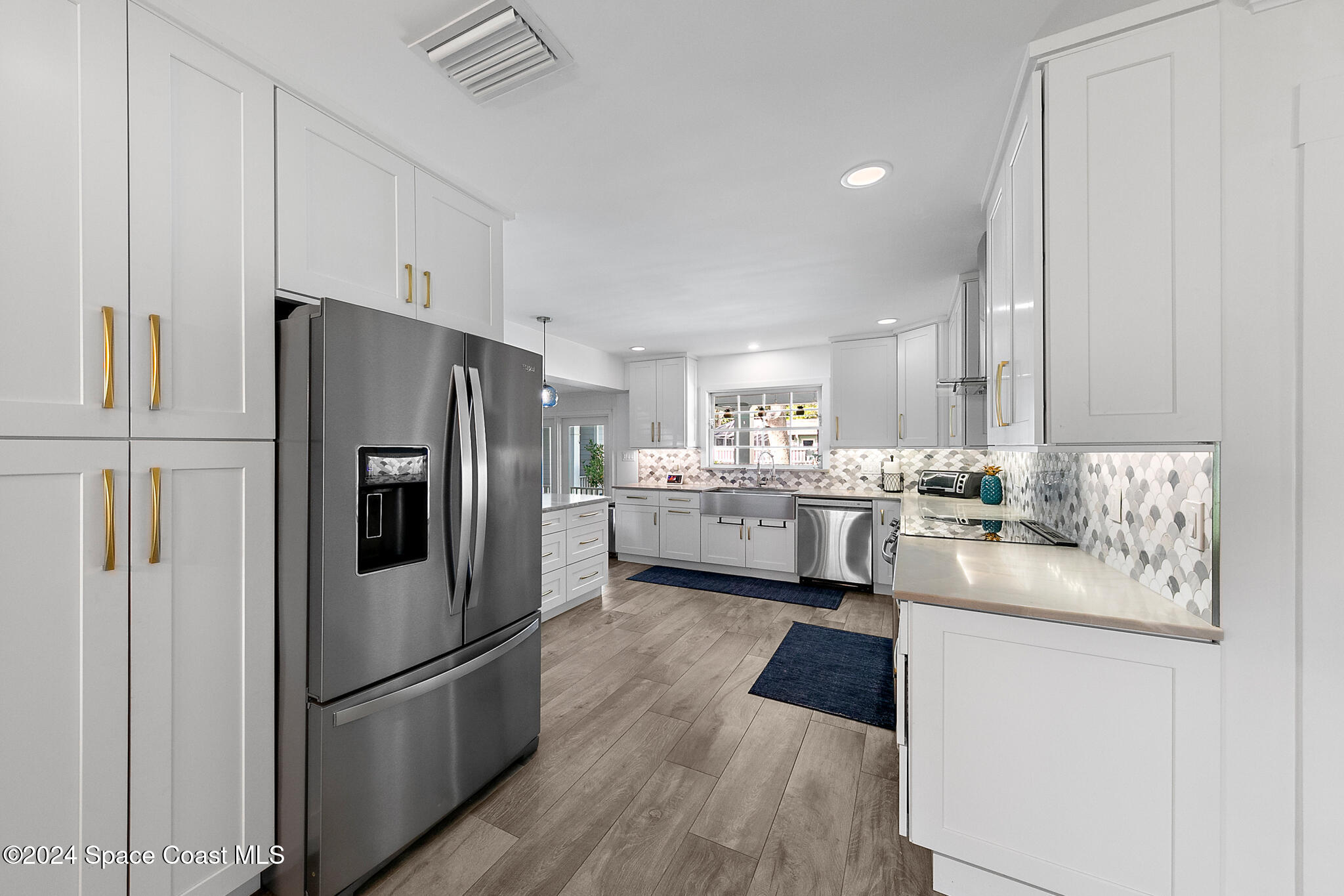 200 Melbourne Avenue Indialantic, FL 32903 - Photo 16 of 60 a kitchen with stainless steel appliances a refrigerator sink and cabinets