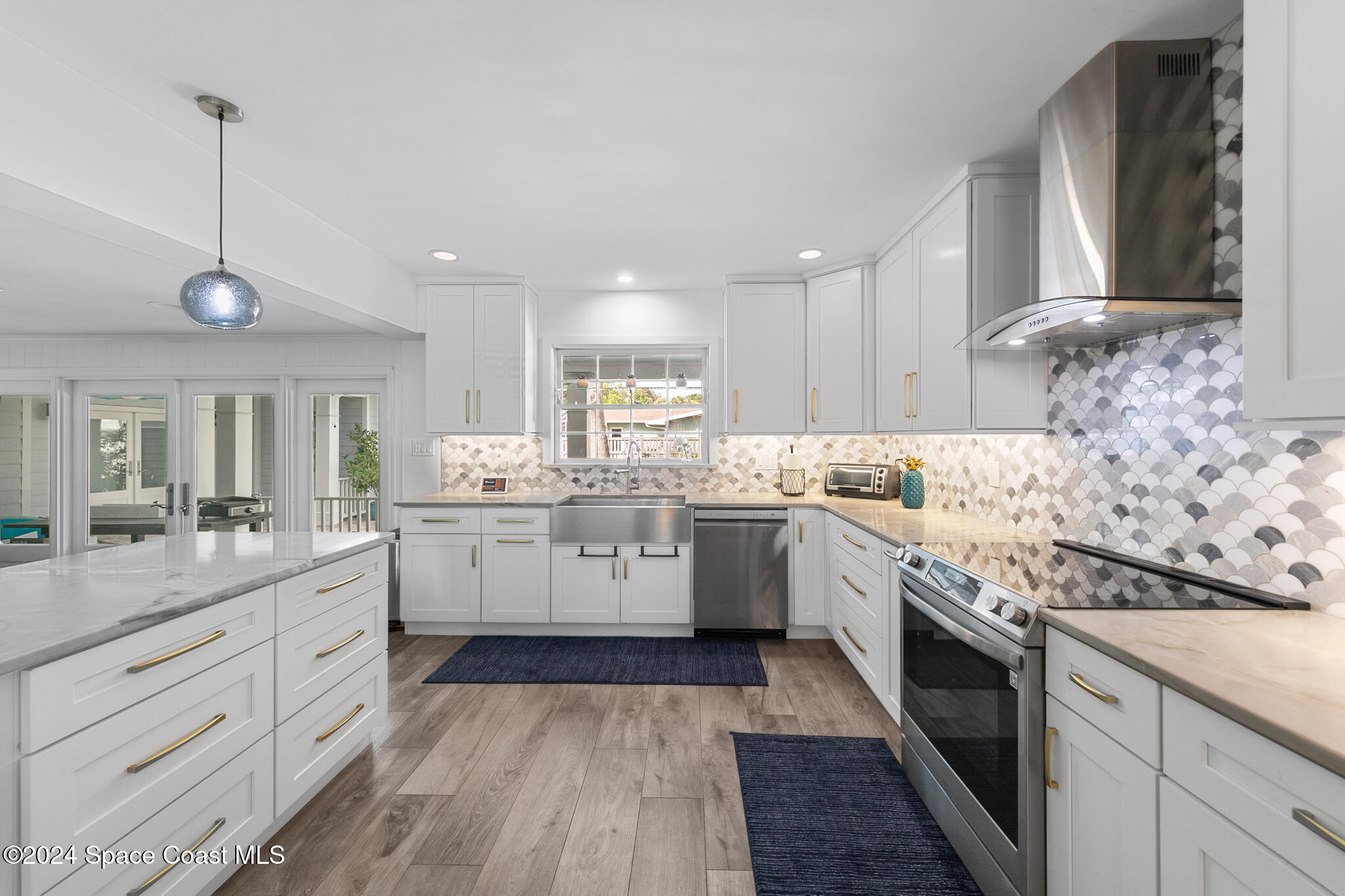 200 Melbourne Avenue Indialantic, FL 32903 - Photo 18 of 60 a kitchen with granite countertop white cabinets and white appliances