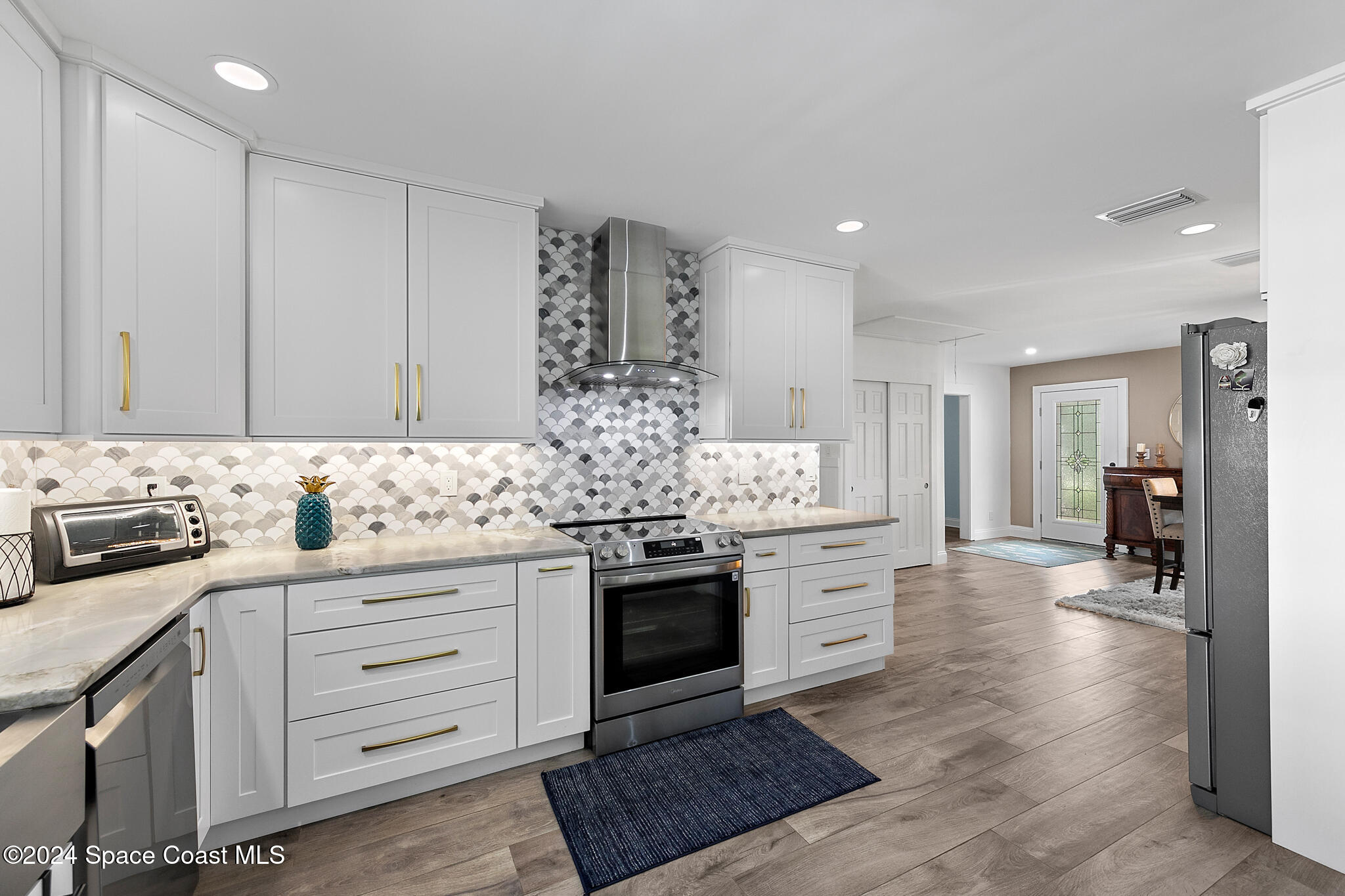 200 Melbourne Avenue Indialantic, FL 32903 - Photo 19 of 60 a kitchen with stainless steel appliances granite countertop a stove and a sink