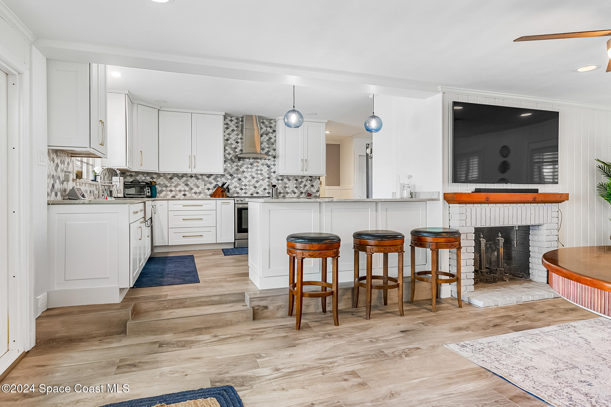 200 Melbourne Avenue Indialantic, FL 32903 - Photo 22 of 60 a kitchen with stainless steel appliances kitchen island granite countertop a table chairs sink and cabinets
