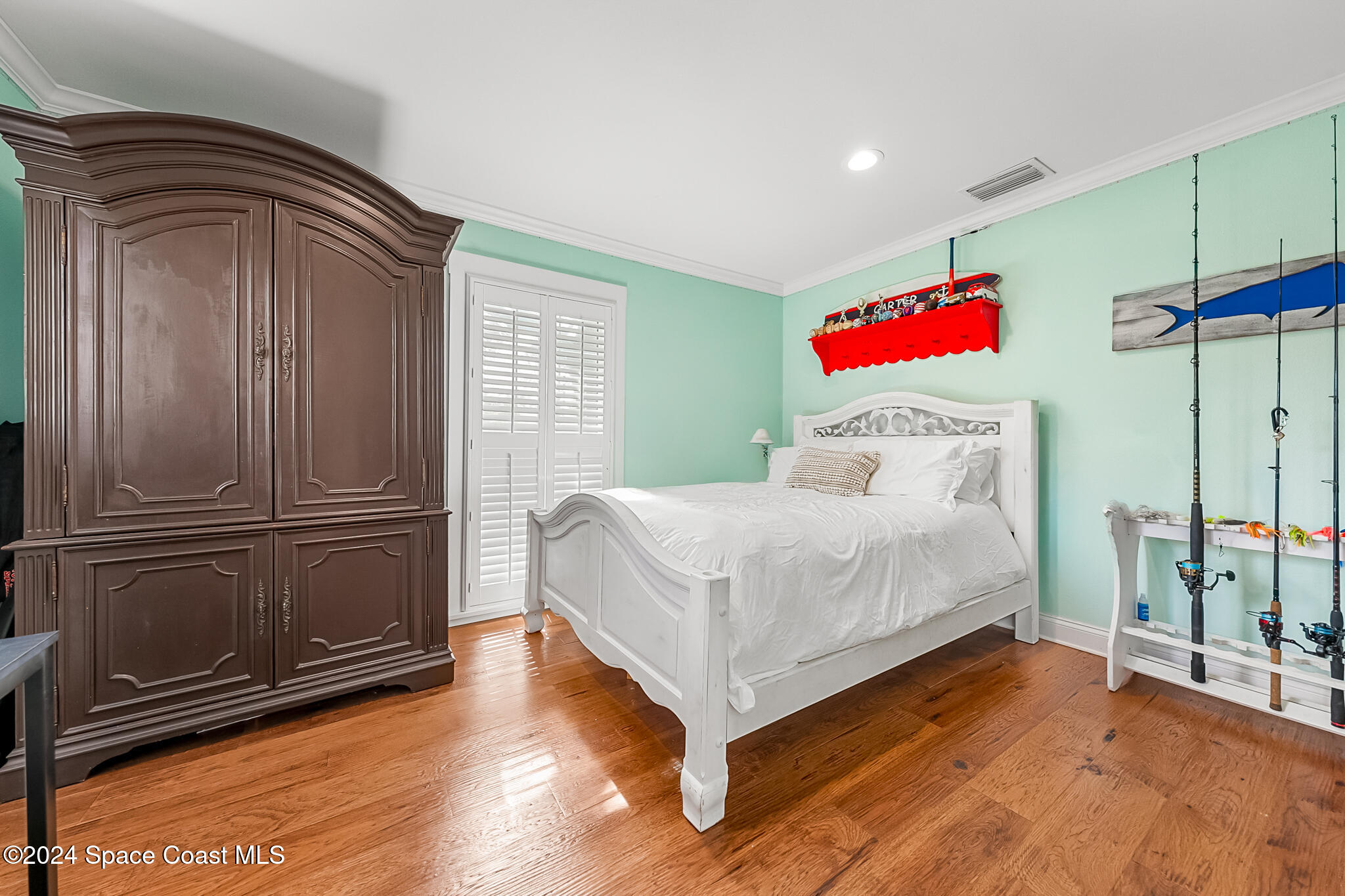 200 Melbourne Avenue Indialantic, FL 32903 - Photo 31 of 60 a bedroom with a bed and wooden floor