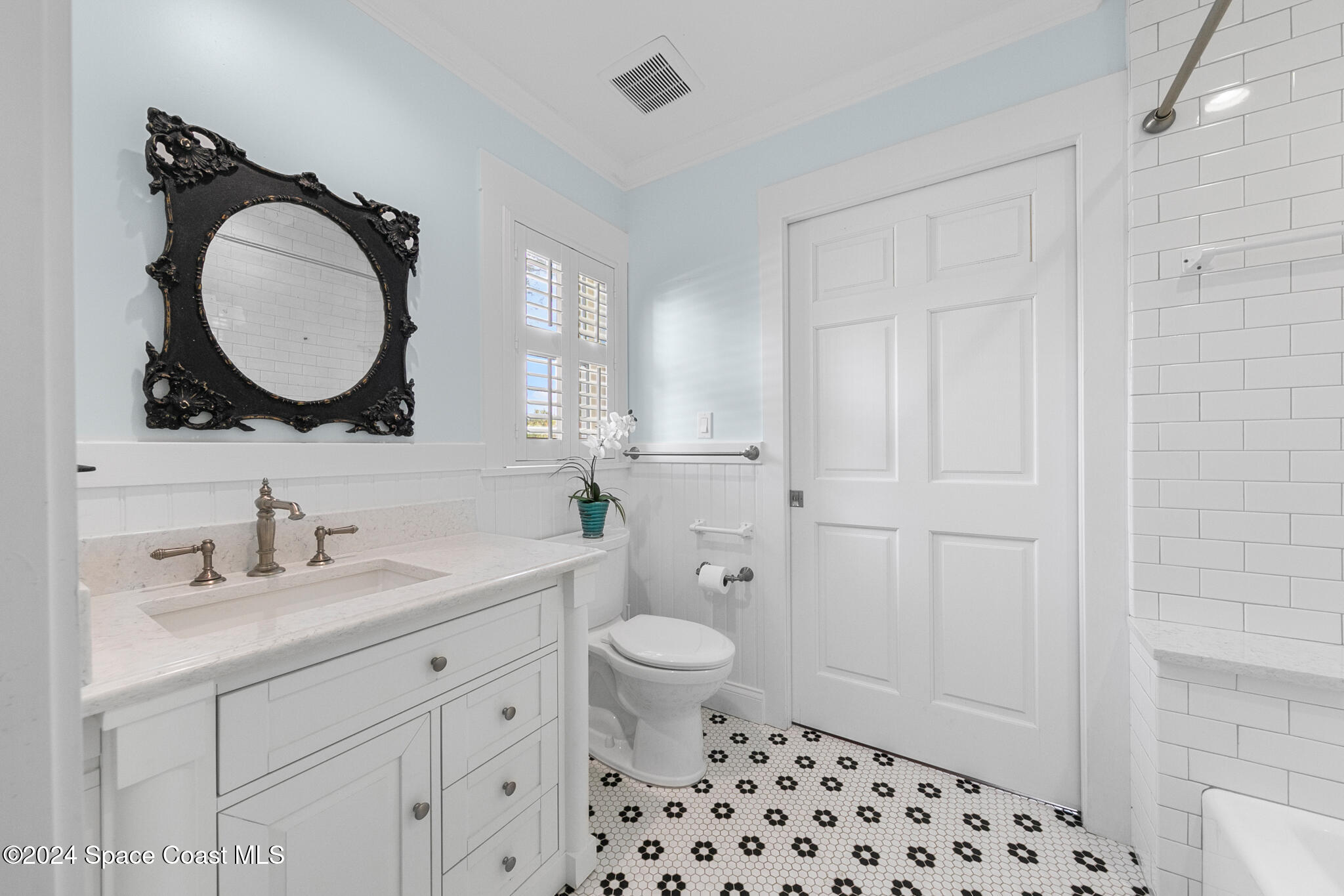 200 Melbourne Avenue Indialantic, FL 32903 - Photo 34 of 60 a bathroom with a toilet a sink a mirror a and a window