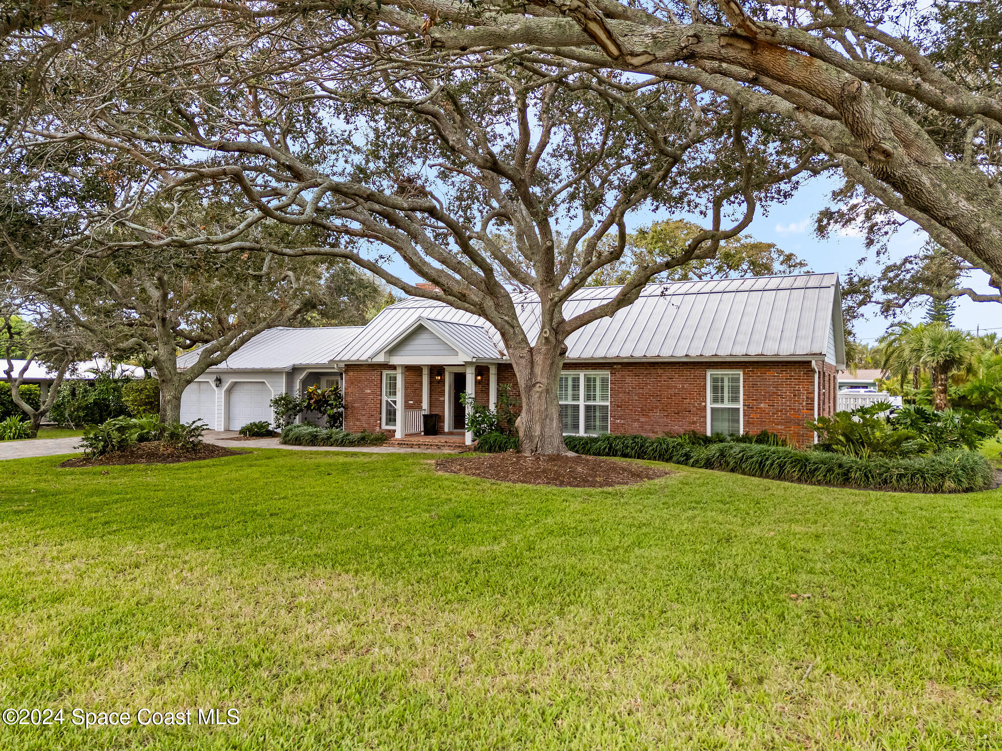 200 Melbourne Avenue Indialantic, FL 32903 - Photo 4 of 60 a front view of a house with garden