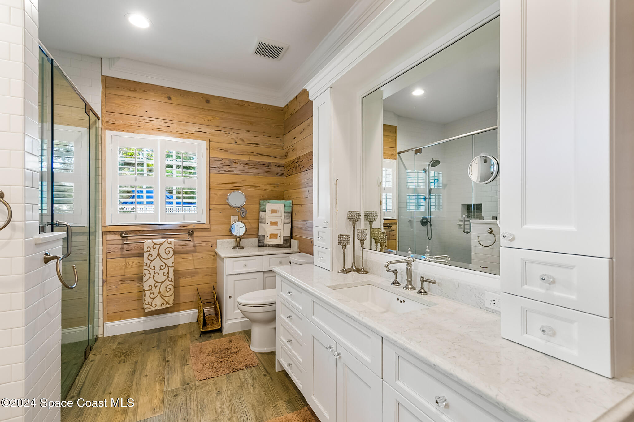 200 Melbourne Avenue Indialantic, FL 32903 - Photo 44 of 60 a spacious bathroom with a double vanity sink a large mirror a shower and a bathtub