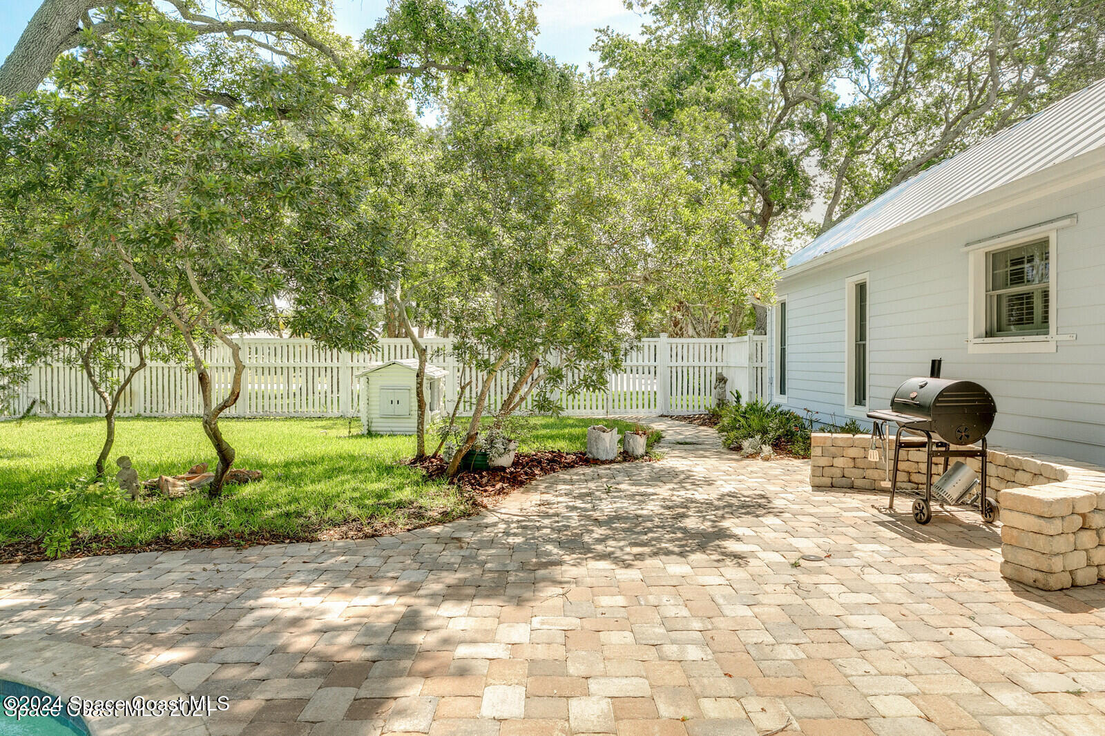 200 Melbourne Avenue Indialantic, FL 32903 - Photo 54 of 60 a view of a backyard with table and chairs and potted plants