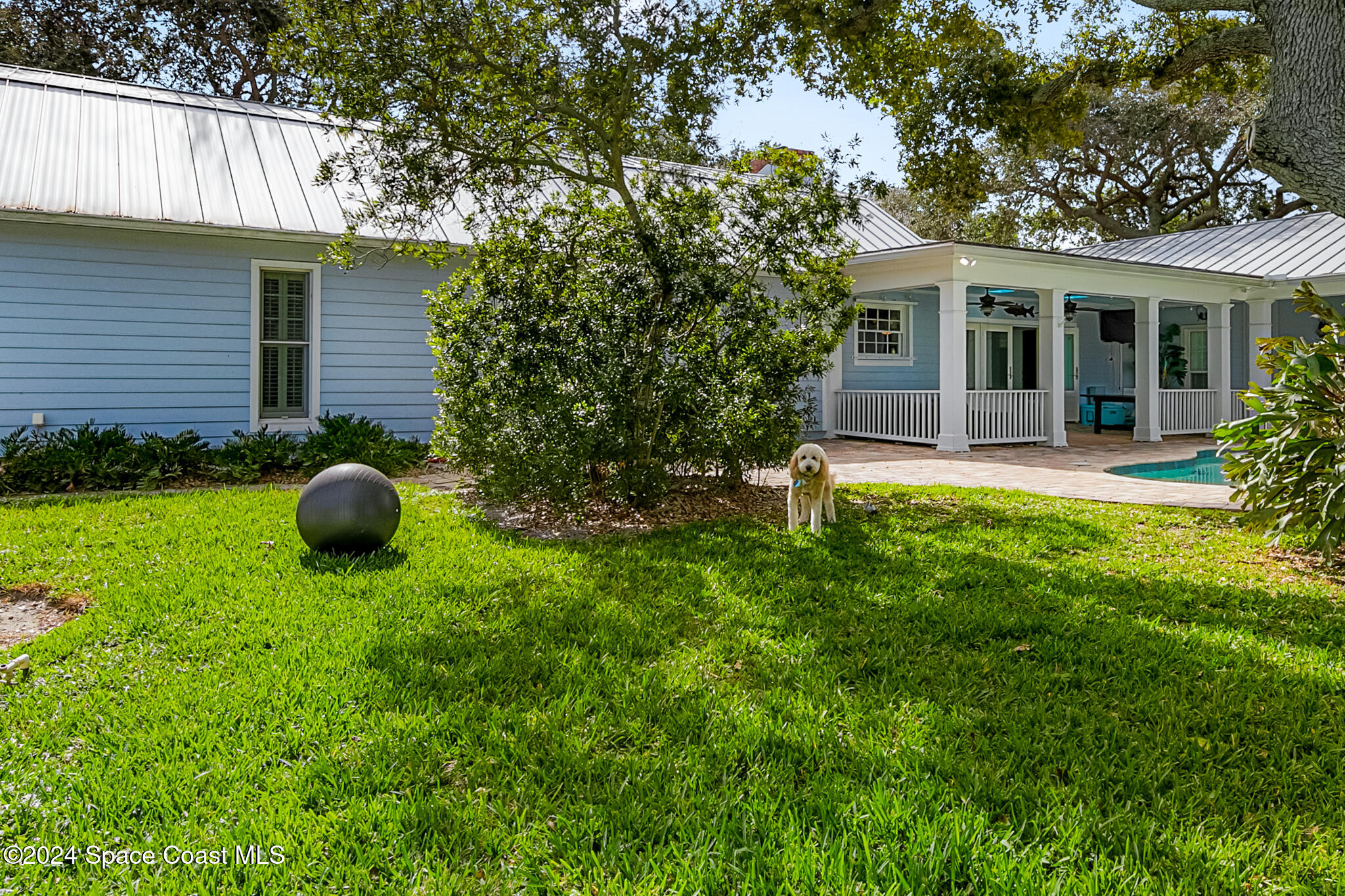 200 Melbourne Avenue Indialantic, FL 32903 - Photo 56 of 60 a view of a backyard with table and chairs and potted plants