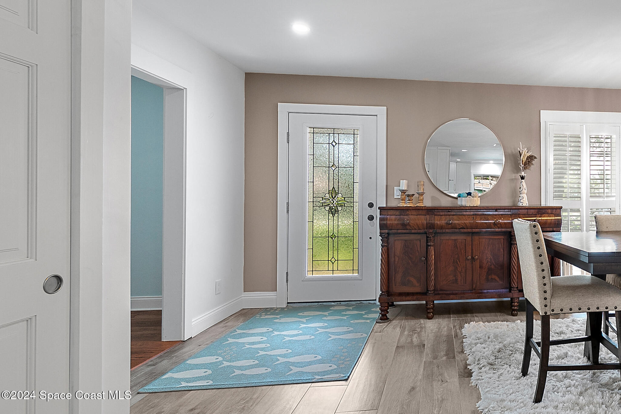 200 Melbourne Avenue Indialantic, FL 32903 - Photo 8 of 60 an empty room with mirror and a wooden floor