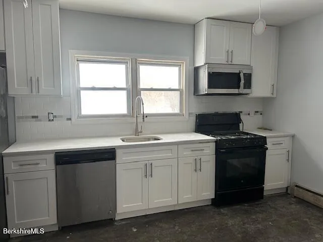 a kitchen with white cabinets and a sink