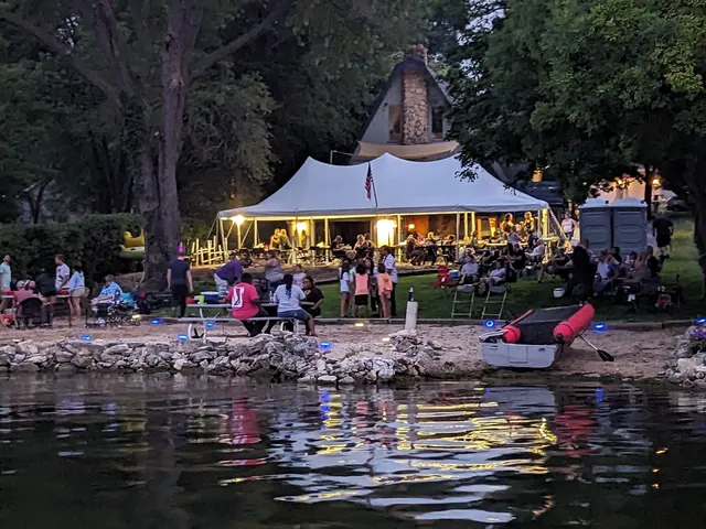 a group of people sitting in front of retail shops