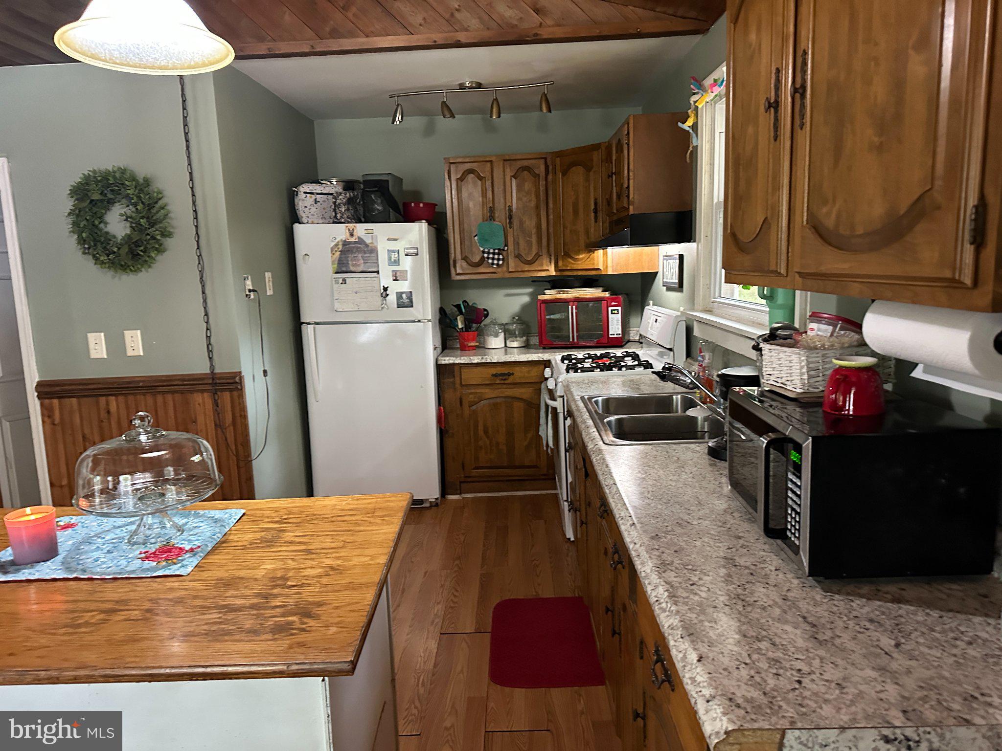 28403 Old Eden Road Eden, MD 21822 - Photo 29 of 46 a kitchen with kitchen island granite countertop a sink stove and refrigerator