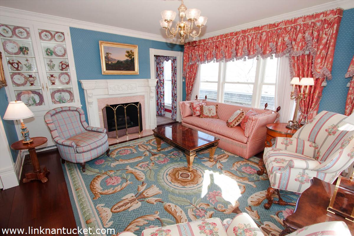 27 Cliff Road Nantucket, MA 02554 - Photo 8 of 32 a living room with furniture a large window and a fireplace