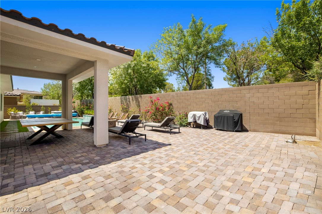 45 Garibaldi Way Henderson, NV 89011 - Photo 41 of 74 An inviting backyard oasis features a paved patio, a covered dining area, and a sparkling swimming pool.