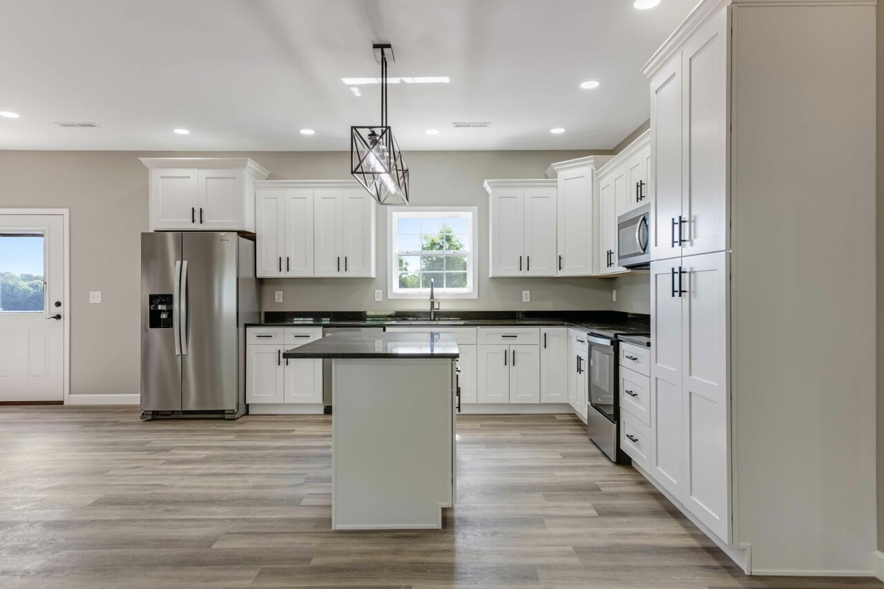 146 Carl Williams Road Crofton, KY 42217 - Photo 11 of 30 a kitchen with kitchen island granite countertop a refrigerator a sink dishwasher a stove and white cabinets with wooden floor