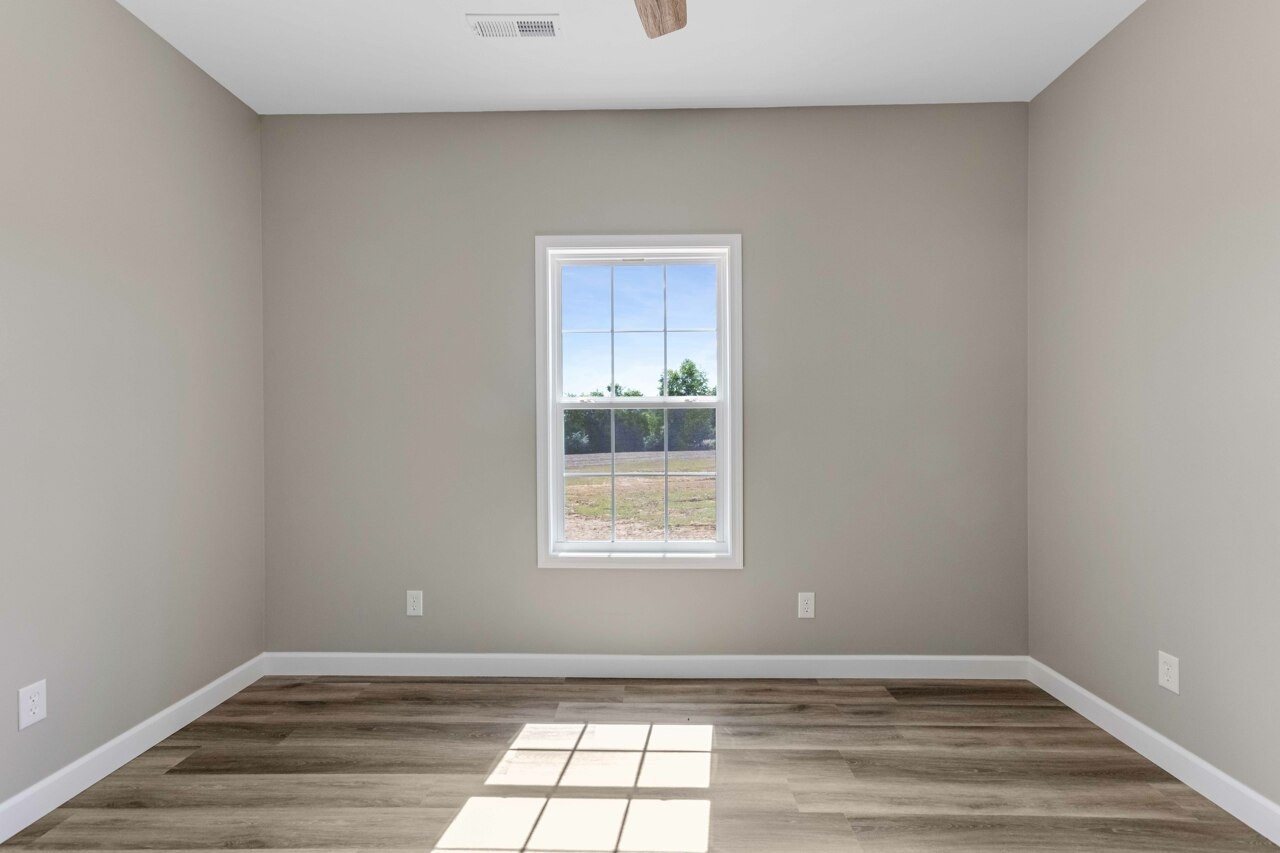 146 Carl Williams Road Crofton, KY 42217 - Photo 23 of 30 a view of an empty room with wooden floor and a window