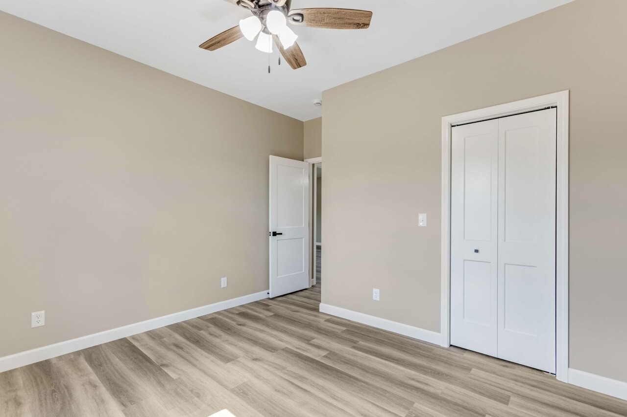 146 Carl Williams Road Crofton, KY 42217 - Photo 24 of 30 a view of an empty room with wooden floor and a ceiling fan