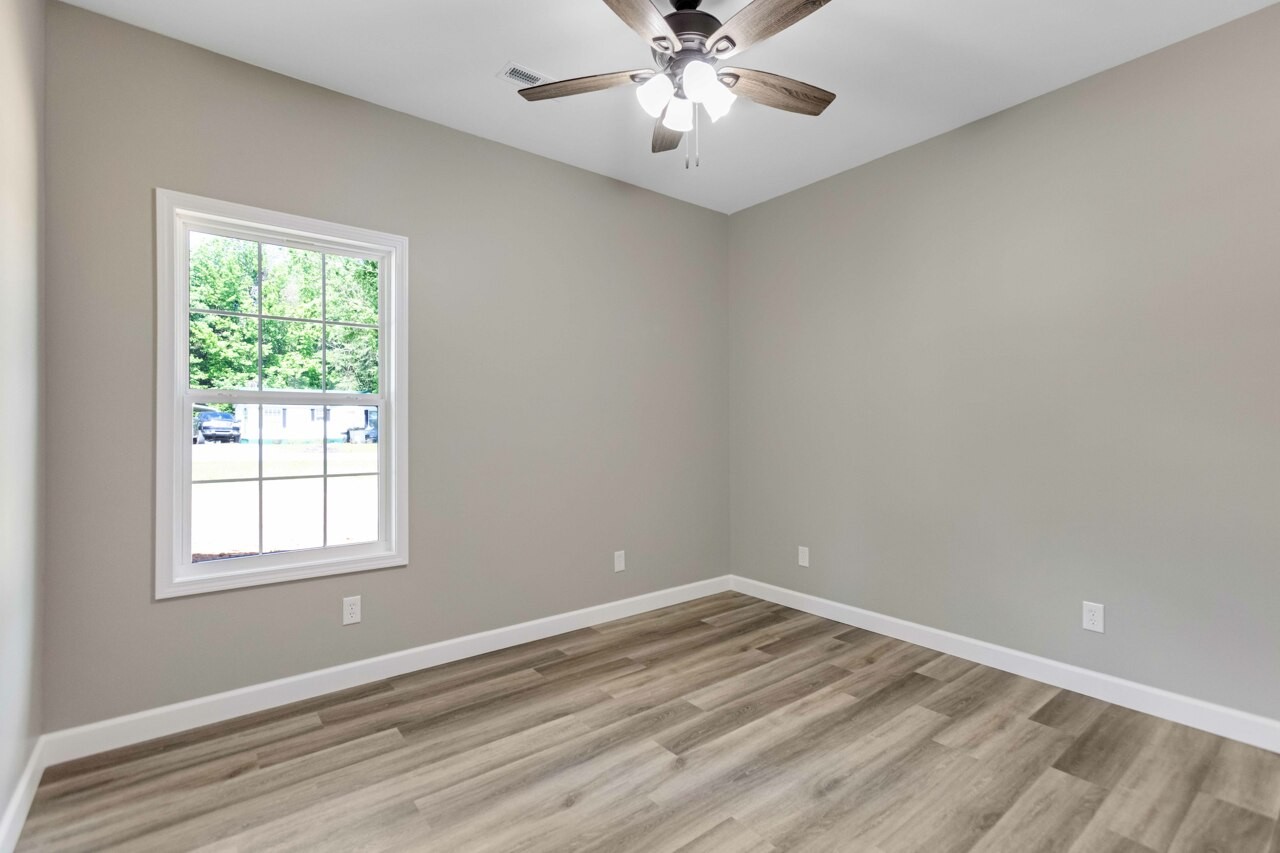 146 Carl Williams Road Crofton, KY 42217 - Photo 25 of 30 a view of empty room with wooden floor and fan