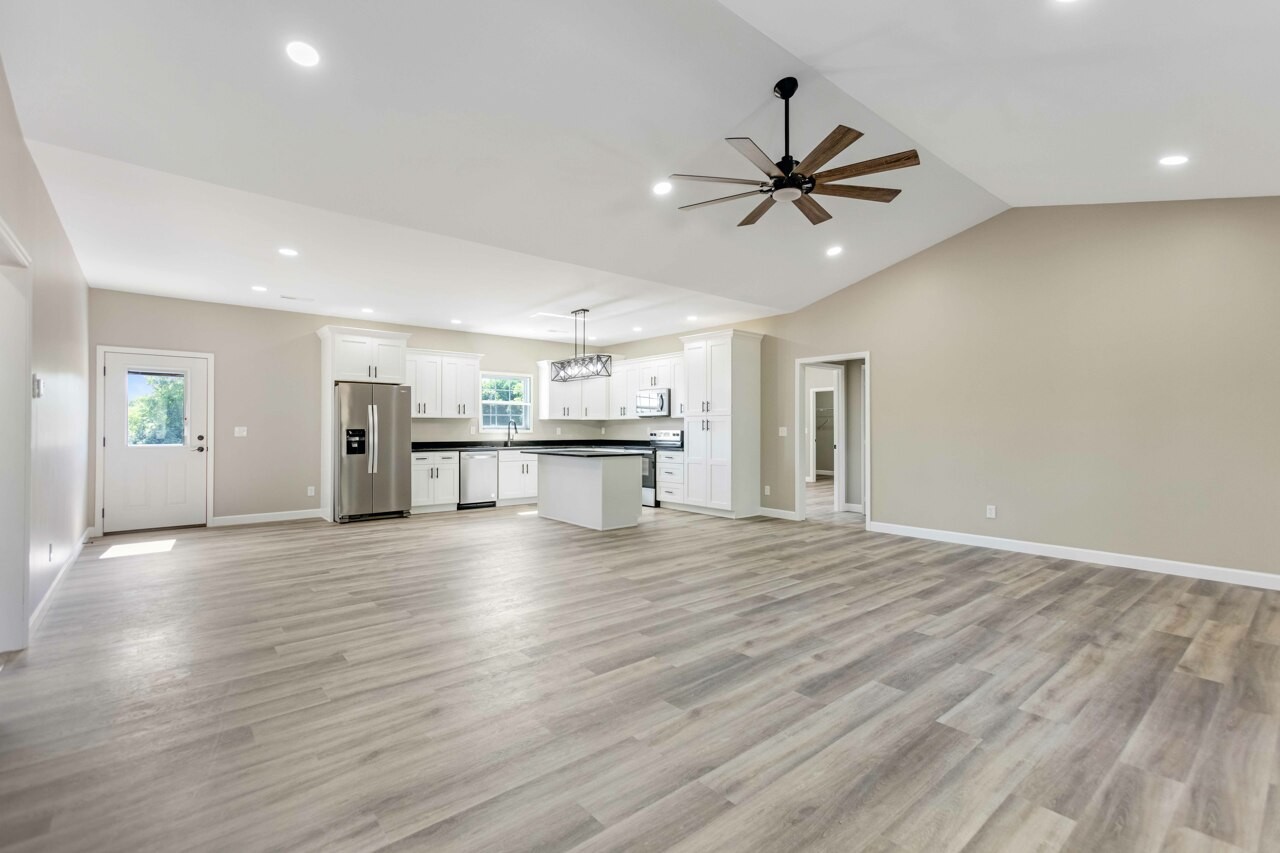 146 Carl Williams Road Crofton, KY 42217 - Photo 5 of 30 a view of a livingroom with wooden floor and a ceiling fan