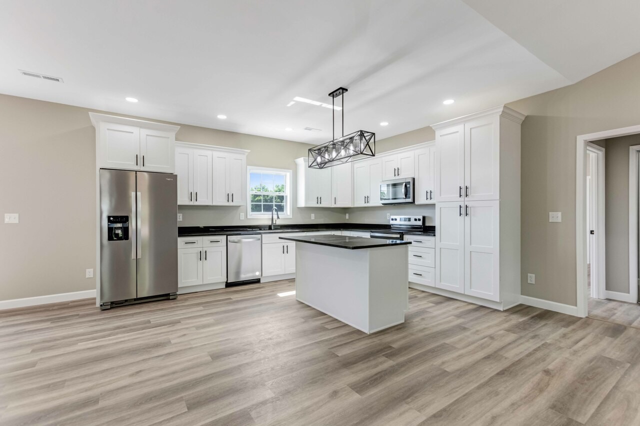 146 Carl Williams Road Crofton, KY 42217 - Photo 8 of 30 a large kitchen with a refrigerator and a stove top oven