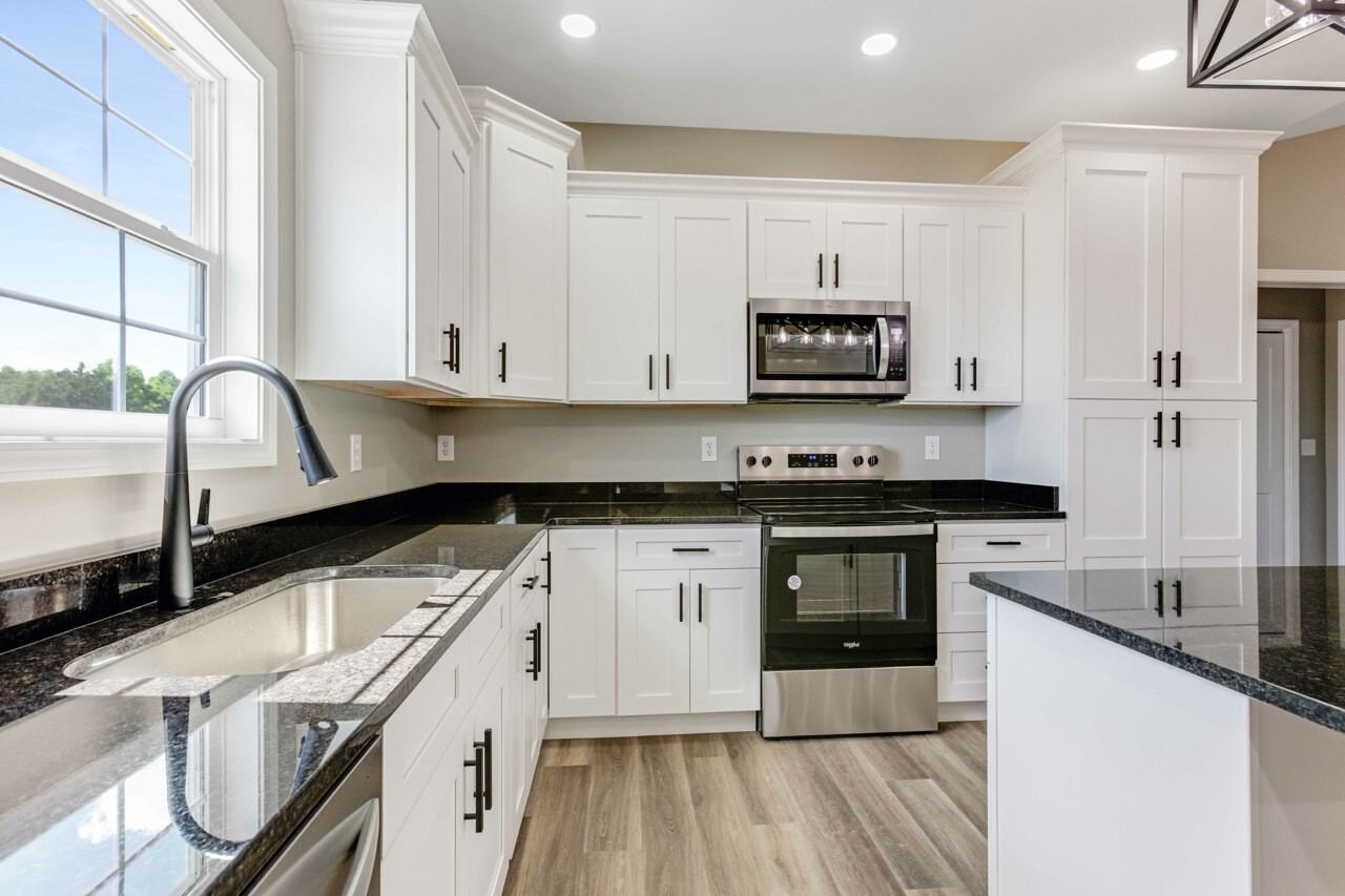 146 Carl Williams Road Crofton, KY 42217 - Photo 9 of 30 a kitchen with stainless steel appliances granite countertop a stove a sink and a microwave