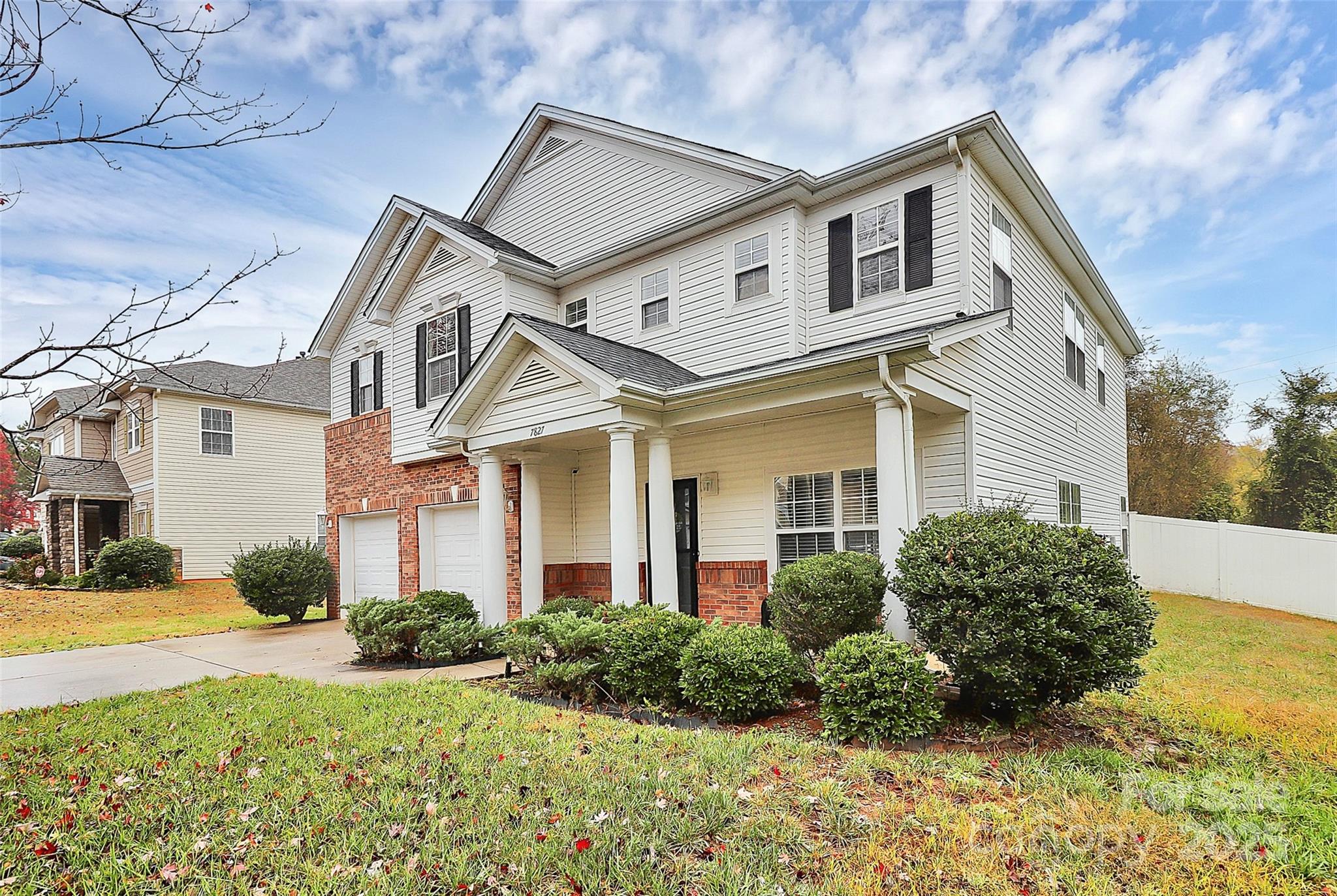 7827 Kuck Road Mint Hill, NC 28227 - Photo 2 of 37 a view of a white house next to a yard with potted plants