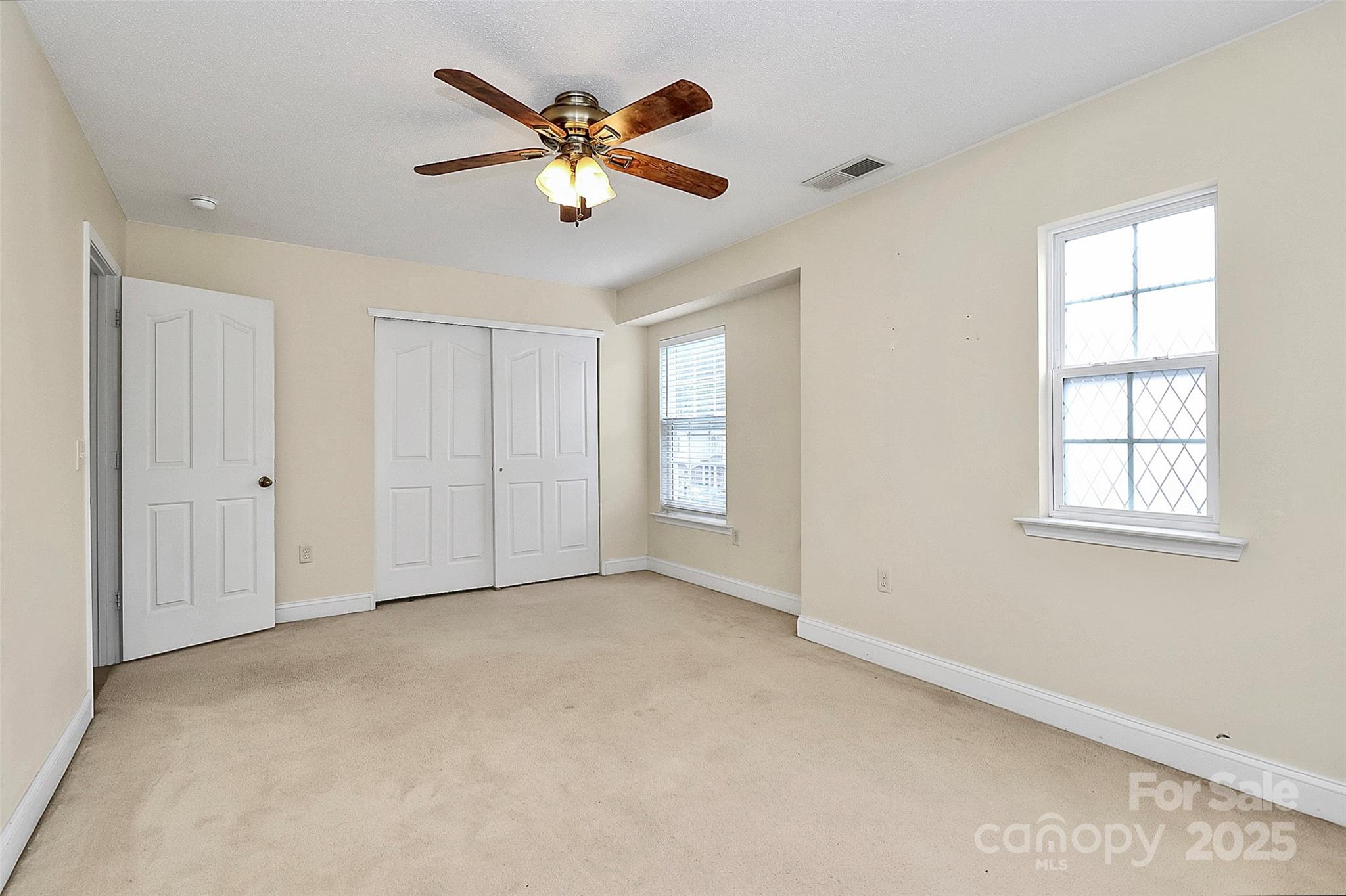 7827 Kuck Road Mint Hill, NC 28227 - Photo 22 of 37 an empty room with windows and fan
