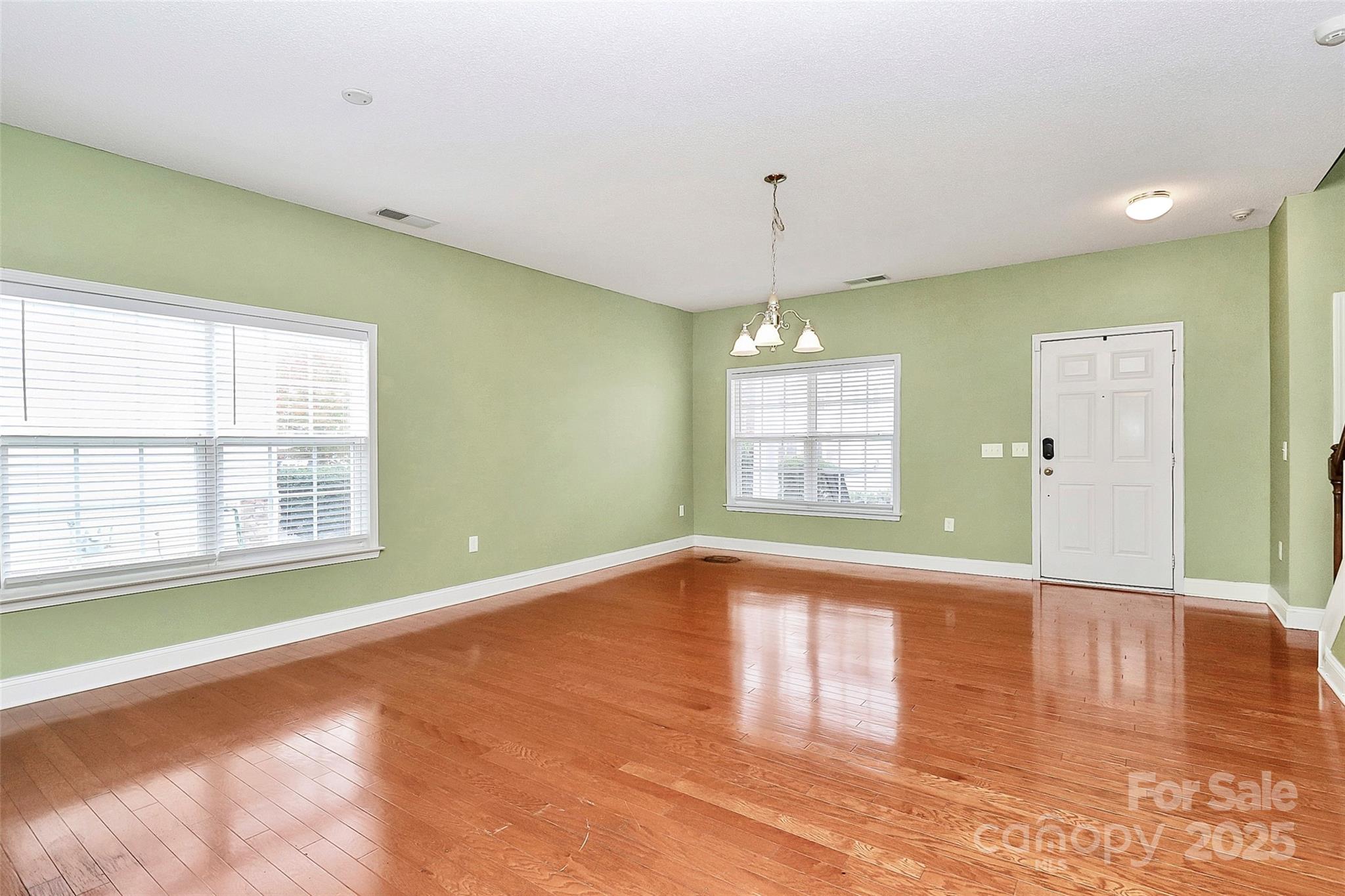 7827 Kuck Road Mint Hill, NC 28227 - Photo 5 of 37 a view of an empty room with window and wooden floor
