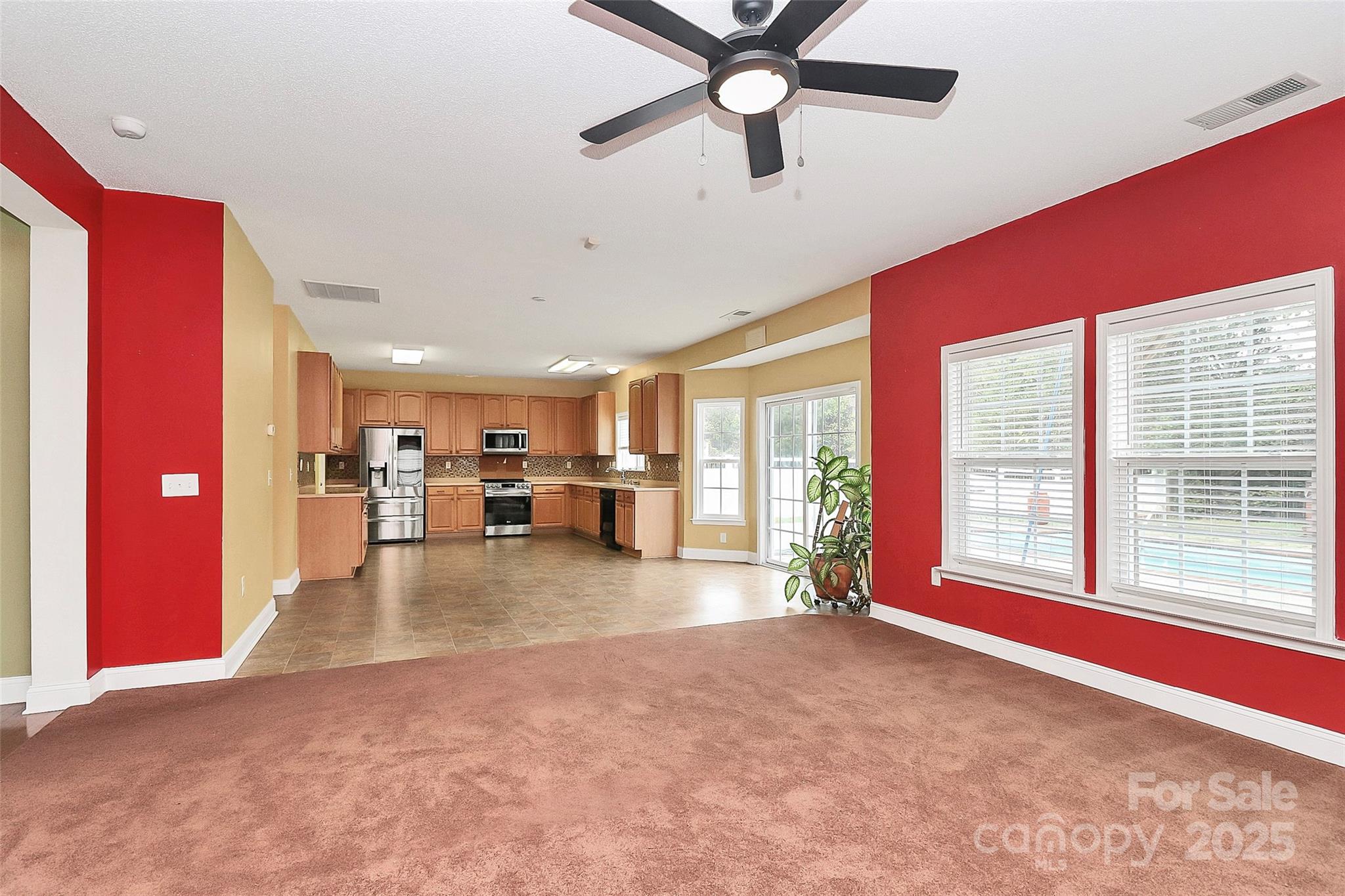 7827 Kuck Road Mint Hill, NC 28227 - Photo 9 of 37 a view of a livingroom with furniture hardwood floor and a ceiling fan