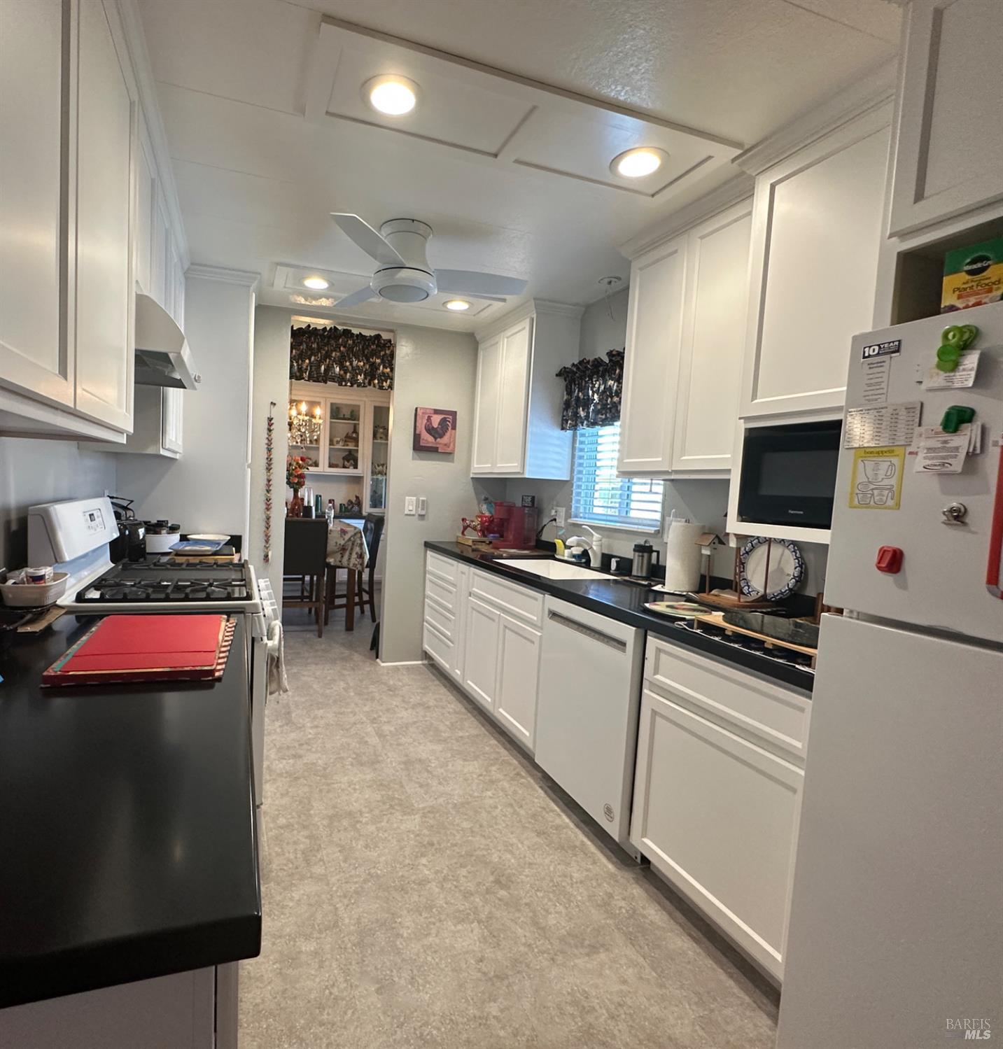 102 Royal Oak Court, Unit 102 Fairfield, CA 94533 - Photo 12 of 32 a kitchen with stainless steel appliances granite countertop a stove a sink and a refrigerator